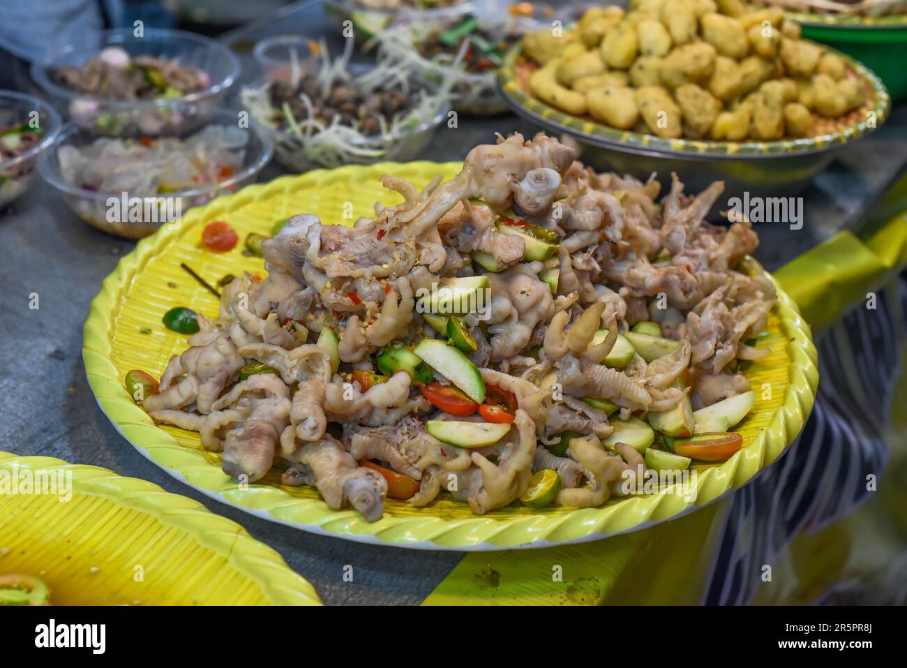Vietnamese favorite snack braised chicken paw in chili sauce in