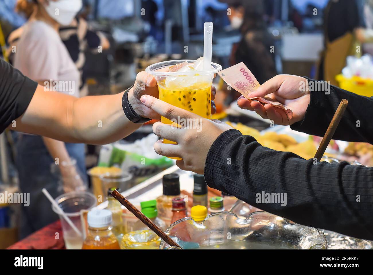 Vietnamese man sells passion fruit juice in plast cup in the night ...