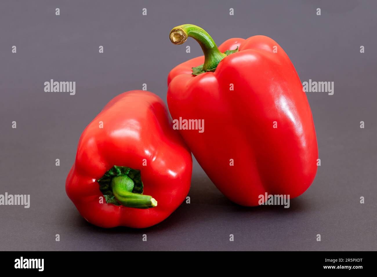 Two Fresh Red Sweet Bell Peppers on Black Background Stock Photo - Alamy