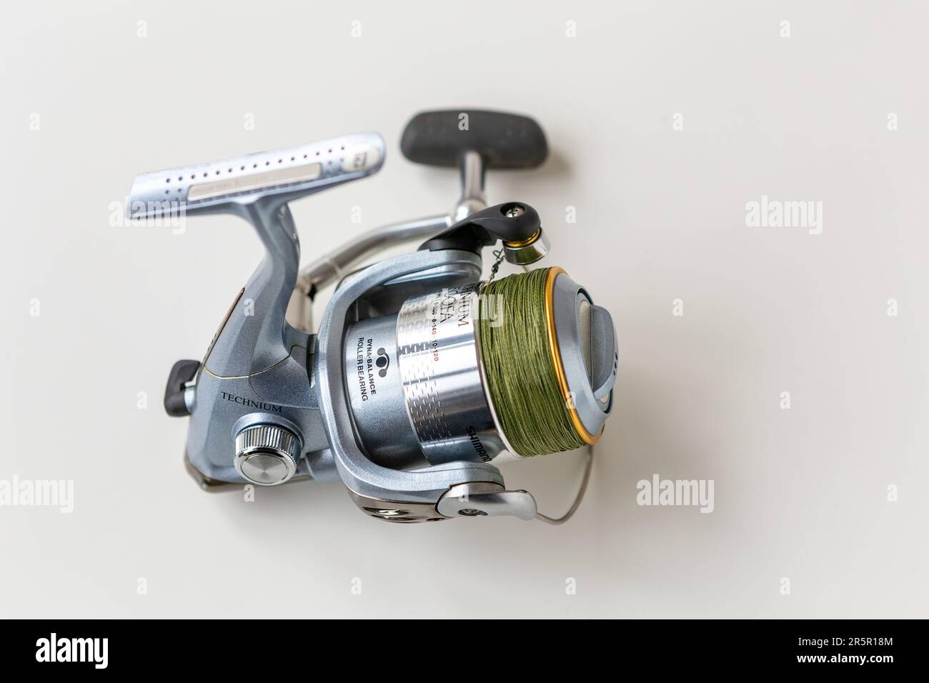 https://c8.alamy.com/comp/2R5R18M/kyiv-ukraine-27-january-2023-blue-steel-fishing-reel-with-cord-wound-on-a-spool-on-a-white-background-shimano-technium-it-is-a-pro-fishing-tool-o-2R5R18M.jpg