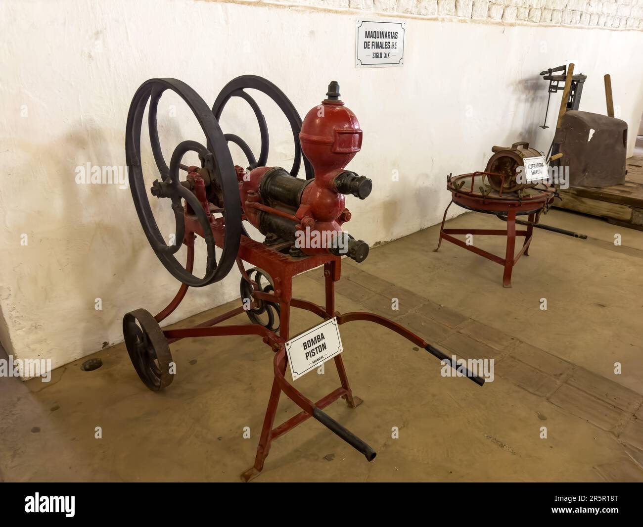 An antique manual piston pump and manual sulfator on display.  La Abeja Winery, San Rafael, Mendoza, Argentina.  These vintage machines were used in g Stock Photo