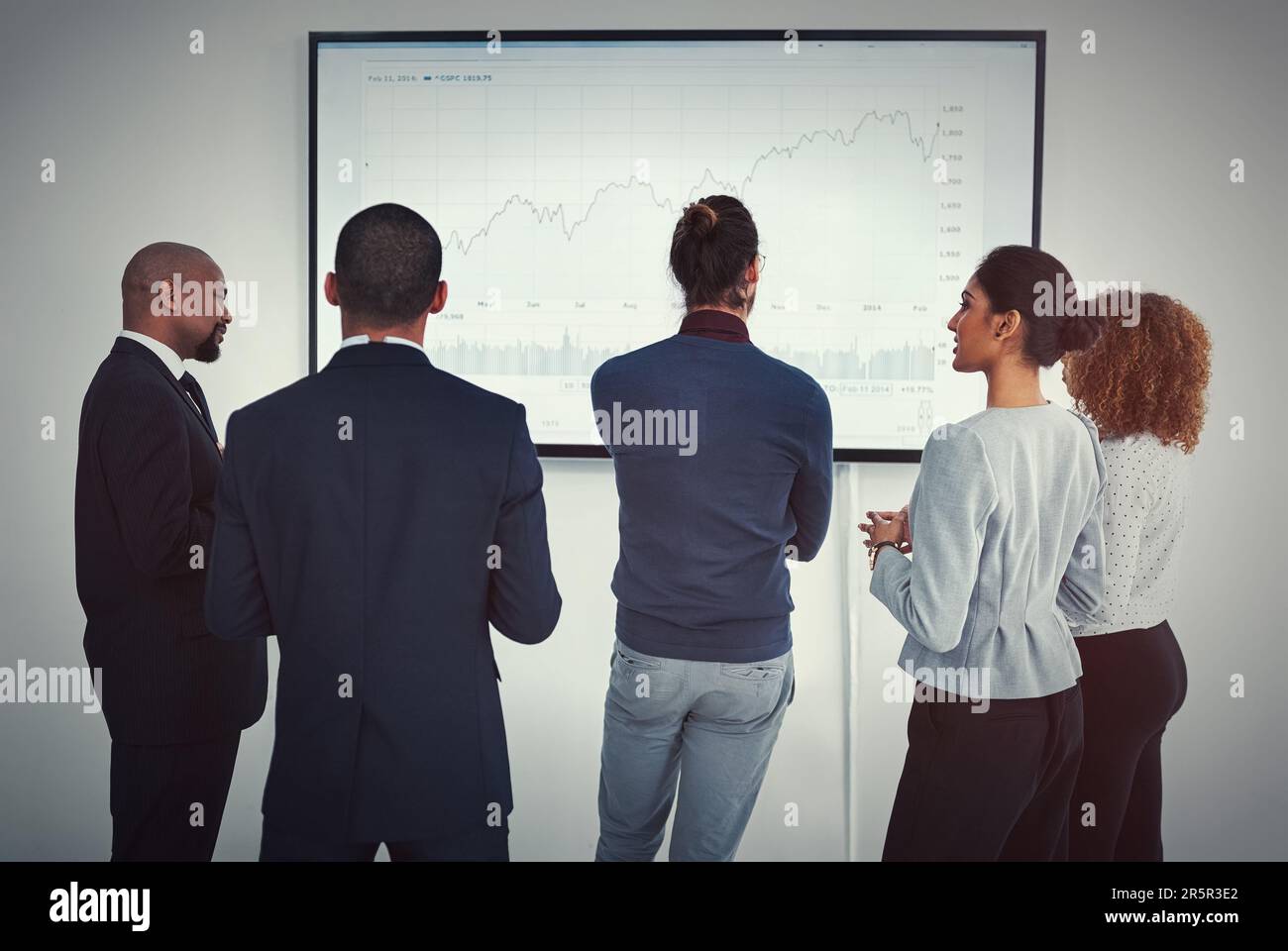 Bringing home the numbers. a young businessman giving a presentation in ...