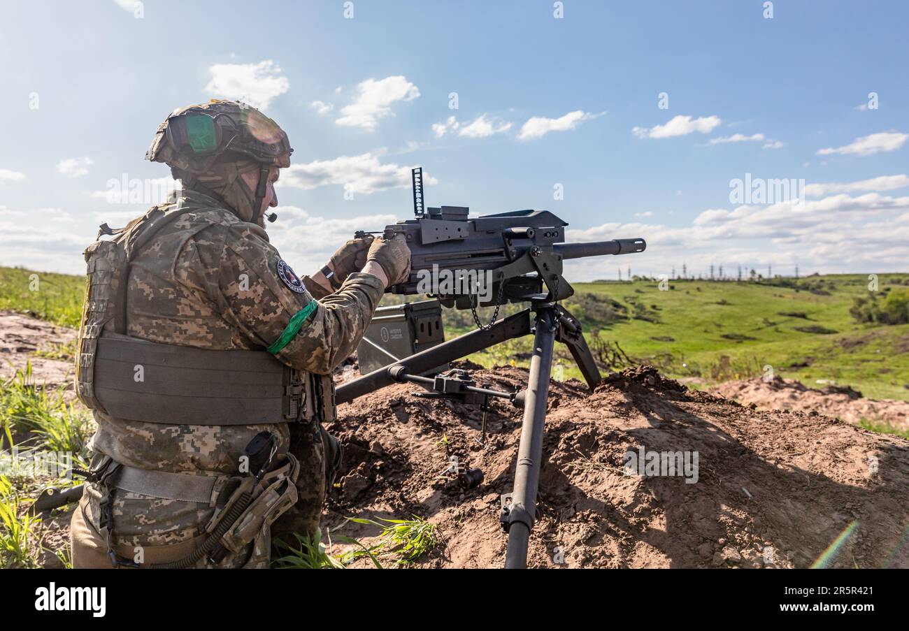 A Ukrainian Armed Forces soldier fires an automatic weapon during ...