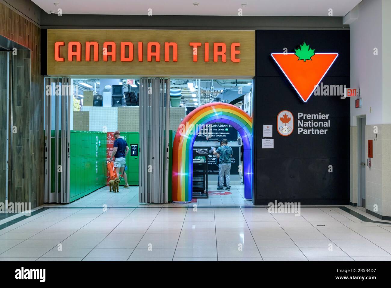 Toronto, Canada - June 4, 2023: Balloon arch with rainbow colors at the entrance of a Canadian Tire store. Traditionally, the city celebrates LGBTQIA Stock Photo