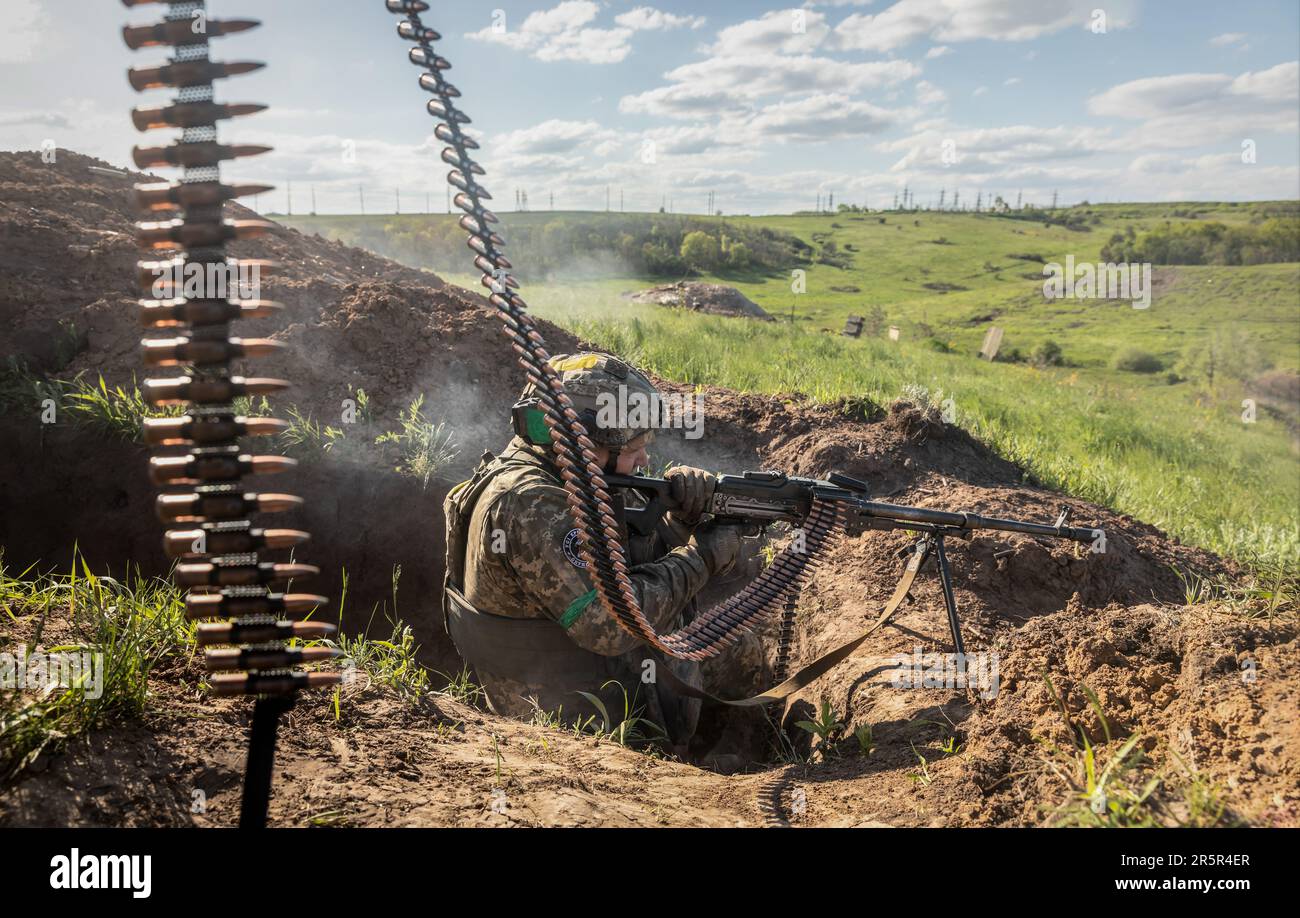 A Ukrainian Armed Forces soldier fires an automatic weapon during ...