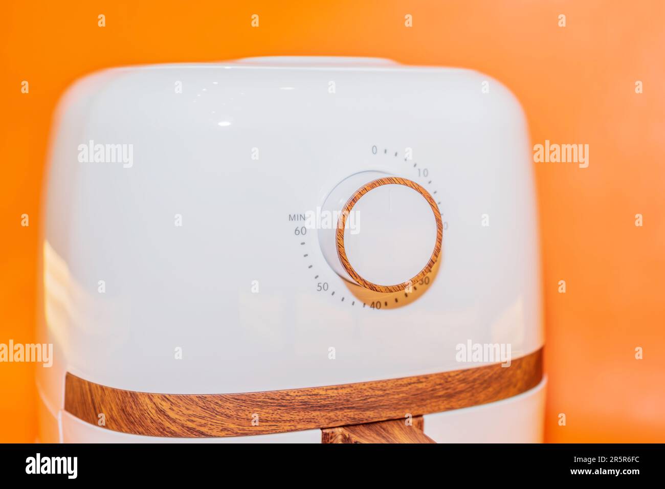 The White Air Fryer with Wooden Handle Design combines functionality