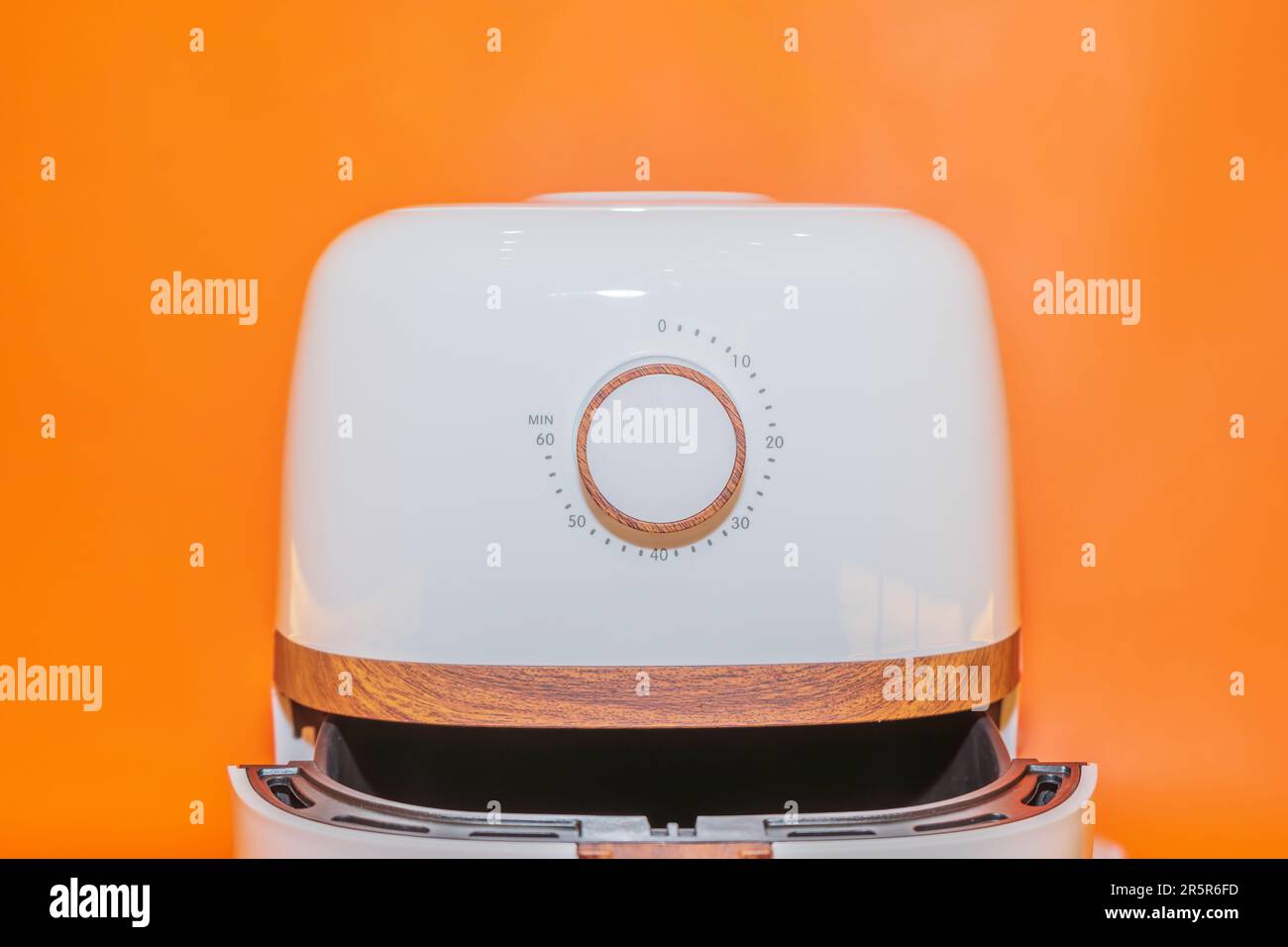 The White Air Fryer with Wooden Handle Design combines functionality