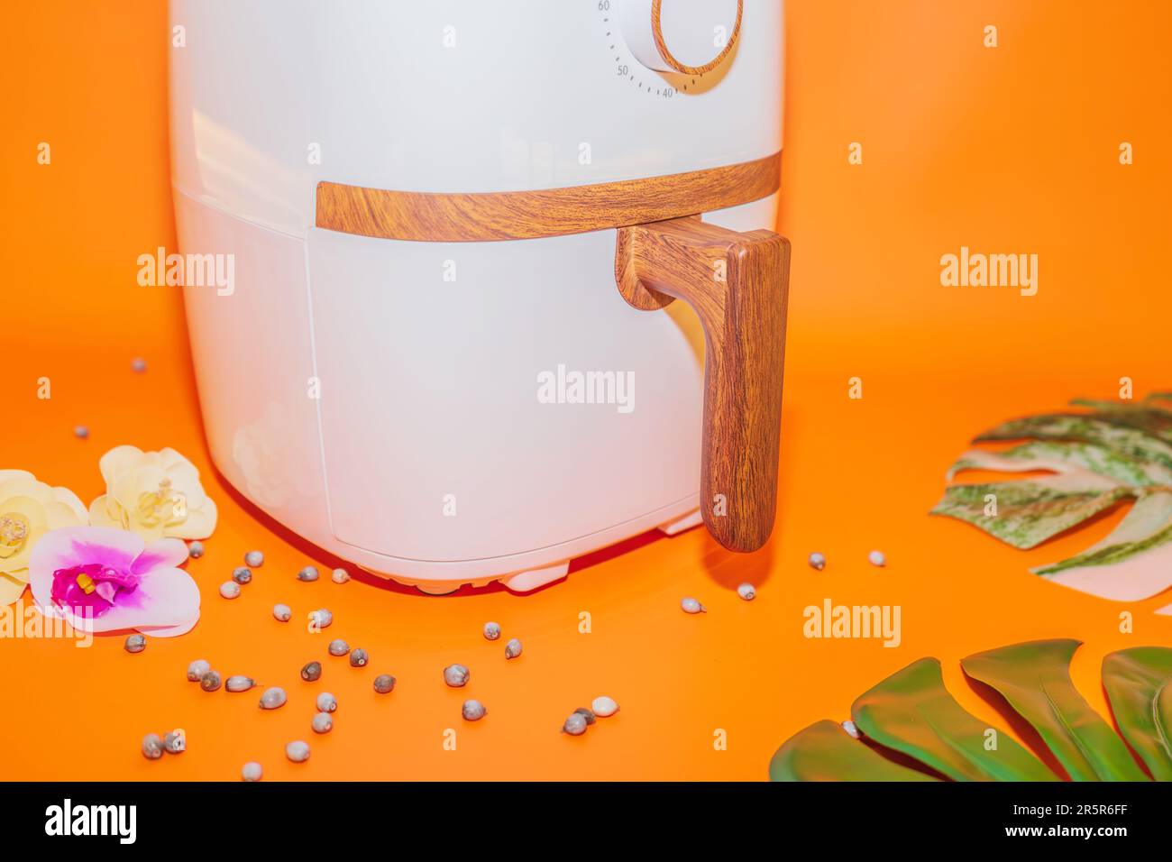 The White Air Fryer with Wooden Handle Design combines functionality