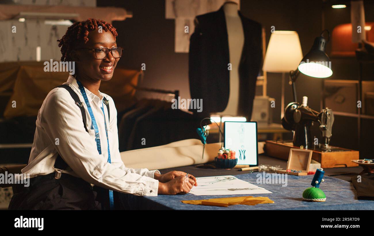 Curated visual reference: Tailor Your Workstation To Your Needs Reference: Female Couturier Works On Clothes Design Looking At Sketches To