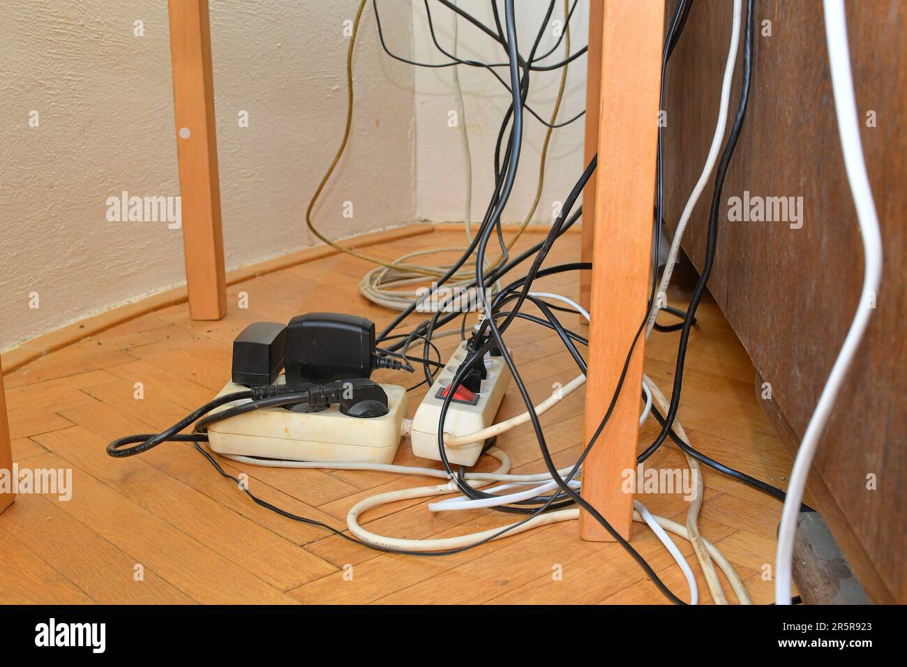 Tangled cables in the extension cord. Messy cables. Cables tangled on