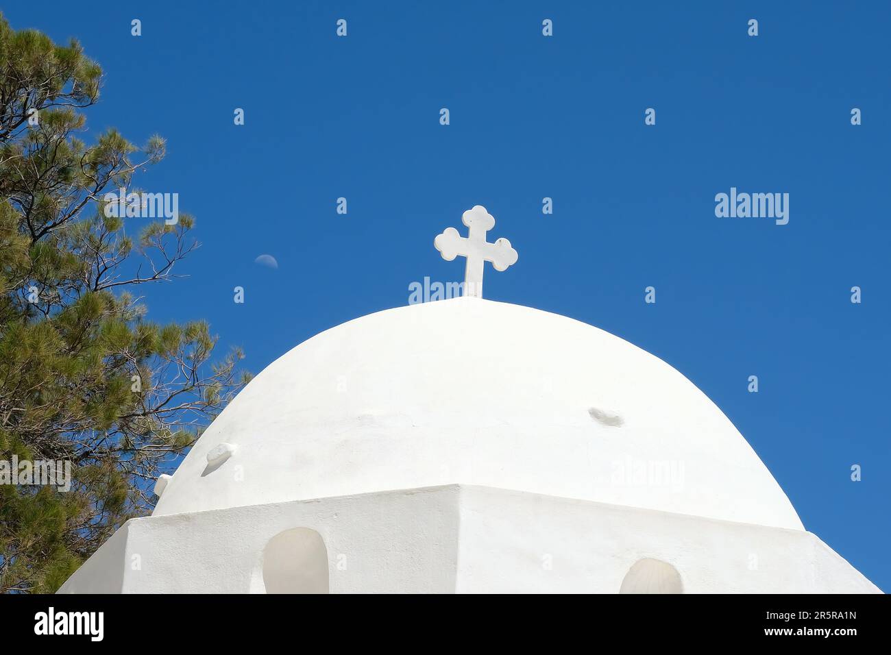 A cross on the top of an orthodox whitewashed church in Ios Greece and ...