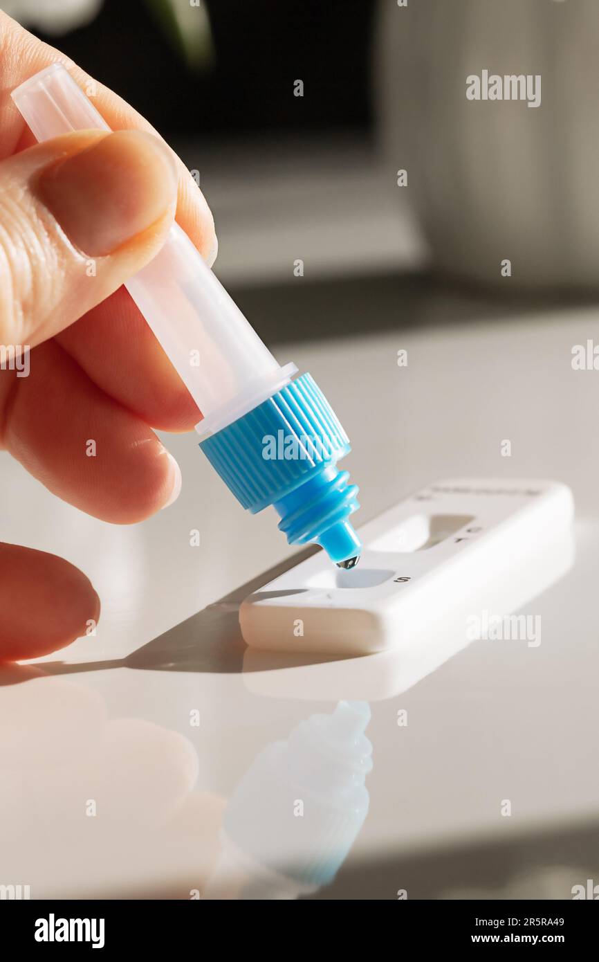 conducting a covid and disease test with a set and arm on a white background Stock Photo