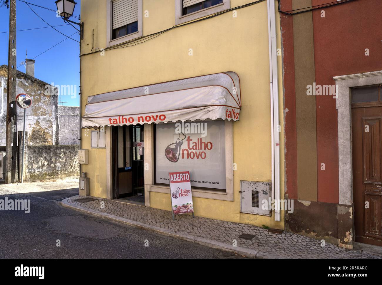 Quiaios, Portugal - August 14, 2022: Exterior of butcher's shop talho novo showing signage and depiction of joint of meat Stock Photo