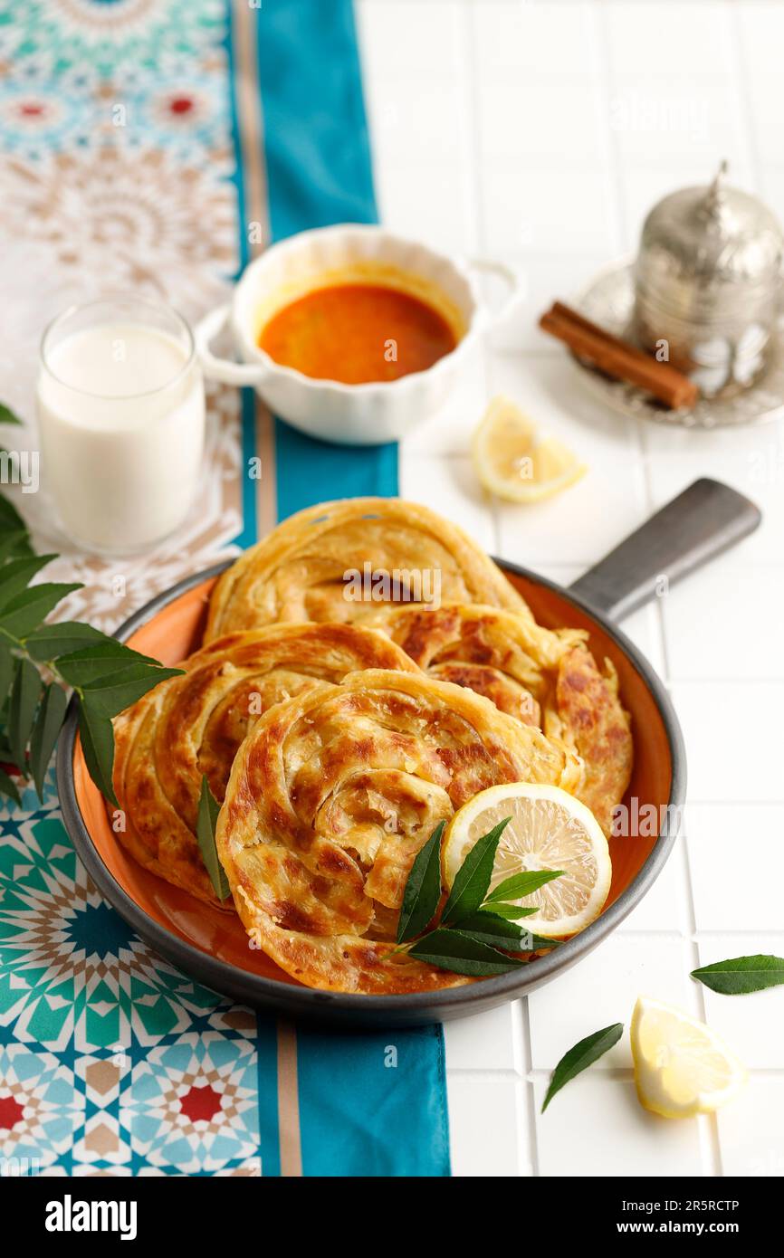 Roti Parata or Roti Canai with Lamb Curry Sauce, Yoghurt and Cinnamon