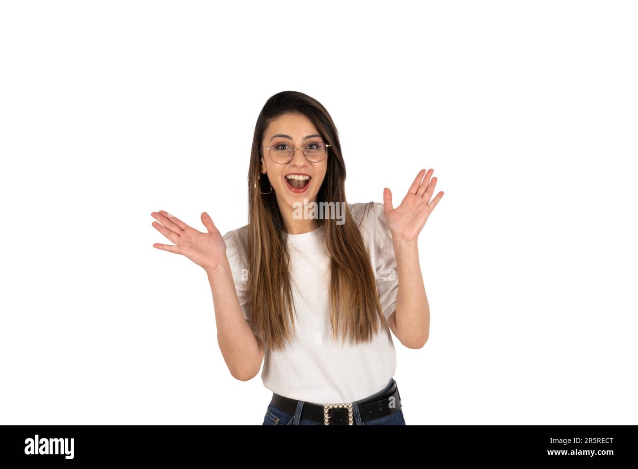 Shocked girl. Isolated white background, copy space. Excited lady taking good news concept idea. Looking camera. Surprised smiling brunette woman. Stock Photo