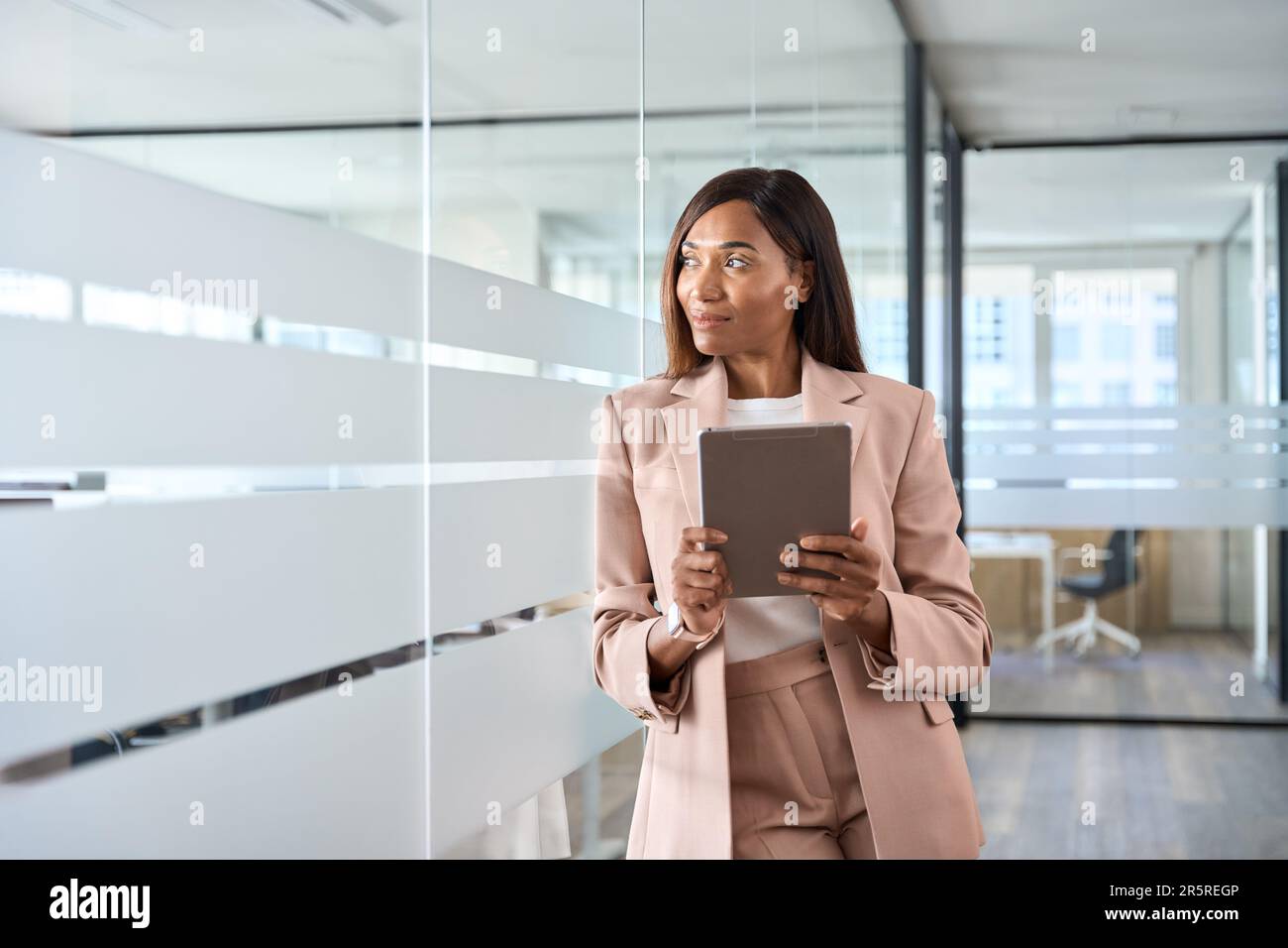 Young African American business woman manager using tablet in office thinking. Stock Photo