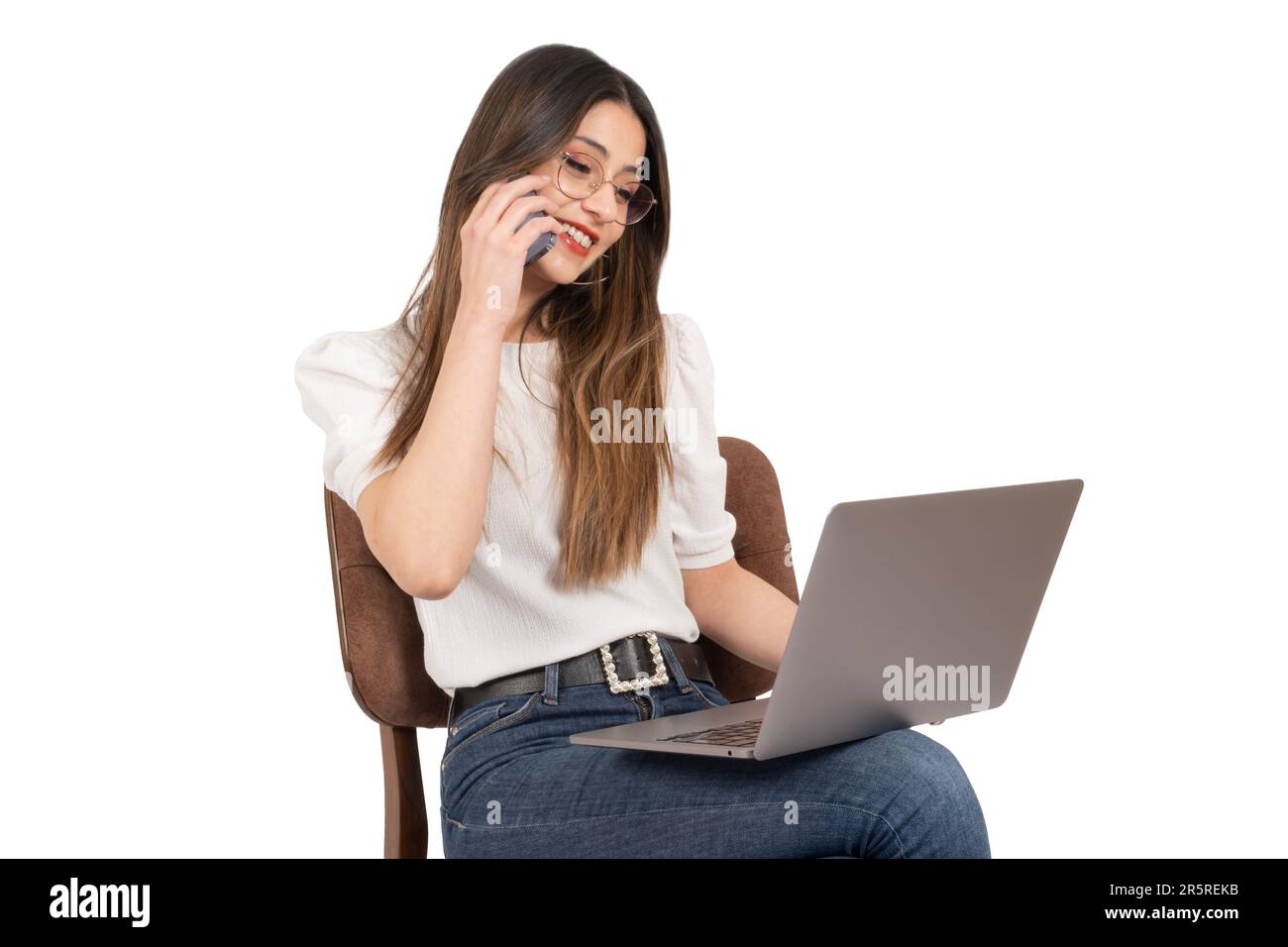 Talking on the phone, side view portrait of modern businesswoman talking on the phone. Smiling happy office worker female sitting on the chair. Stock Photo