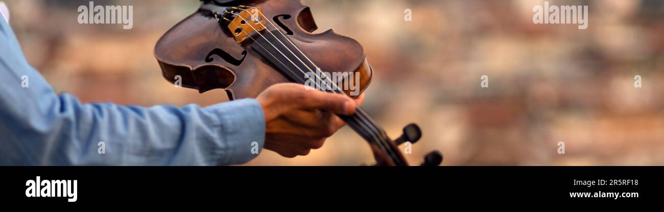 Linkedin banner with an inspired musician holding a violin in his hand Stock Photo