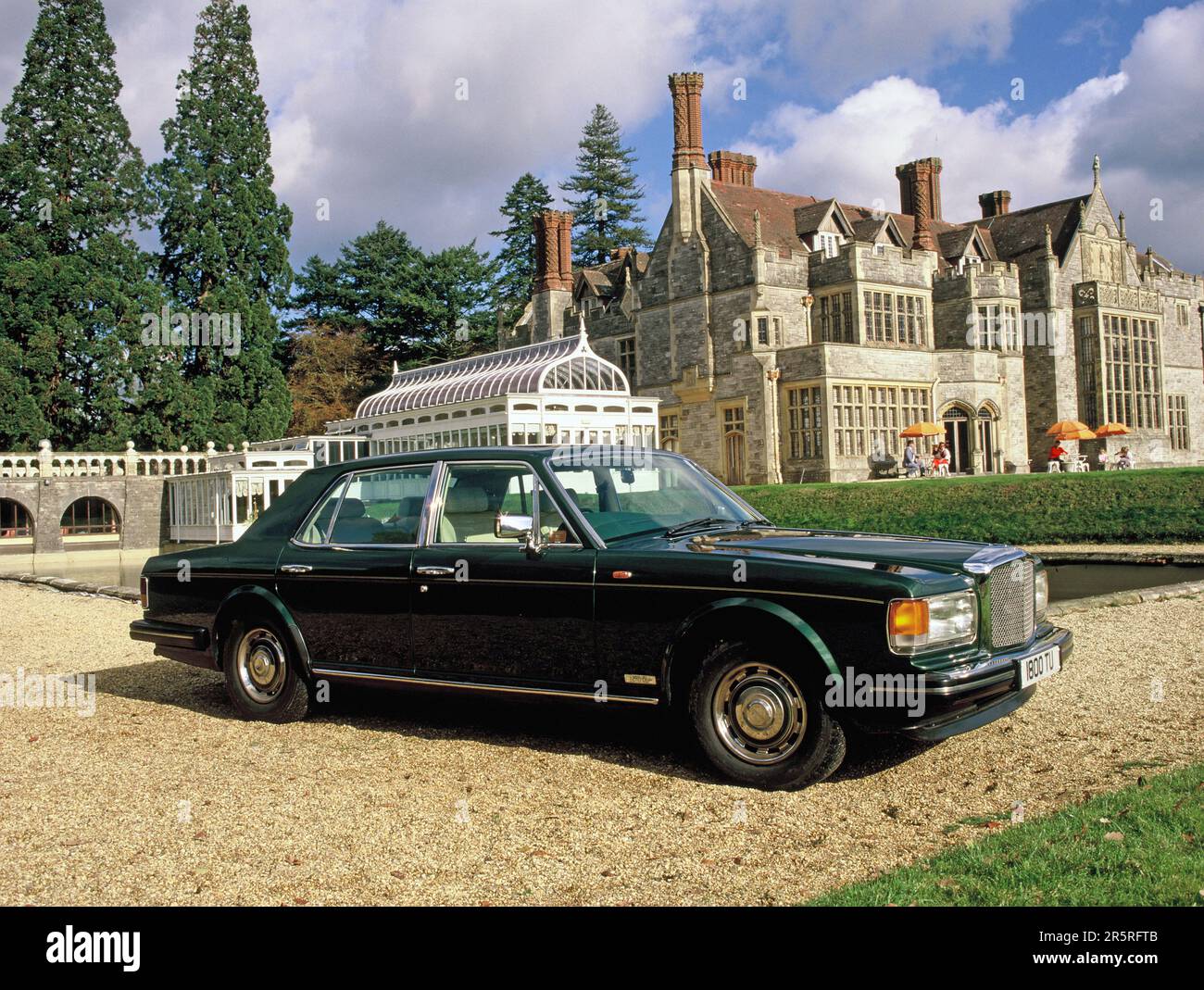 Classic car. 1980's Bentley Mulsane Turbo in front of Rhinefield House Hotel. The New Forest, Hampshire. Stock Photo