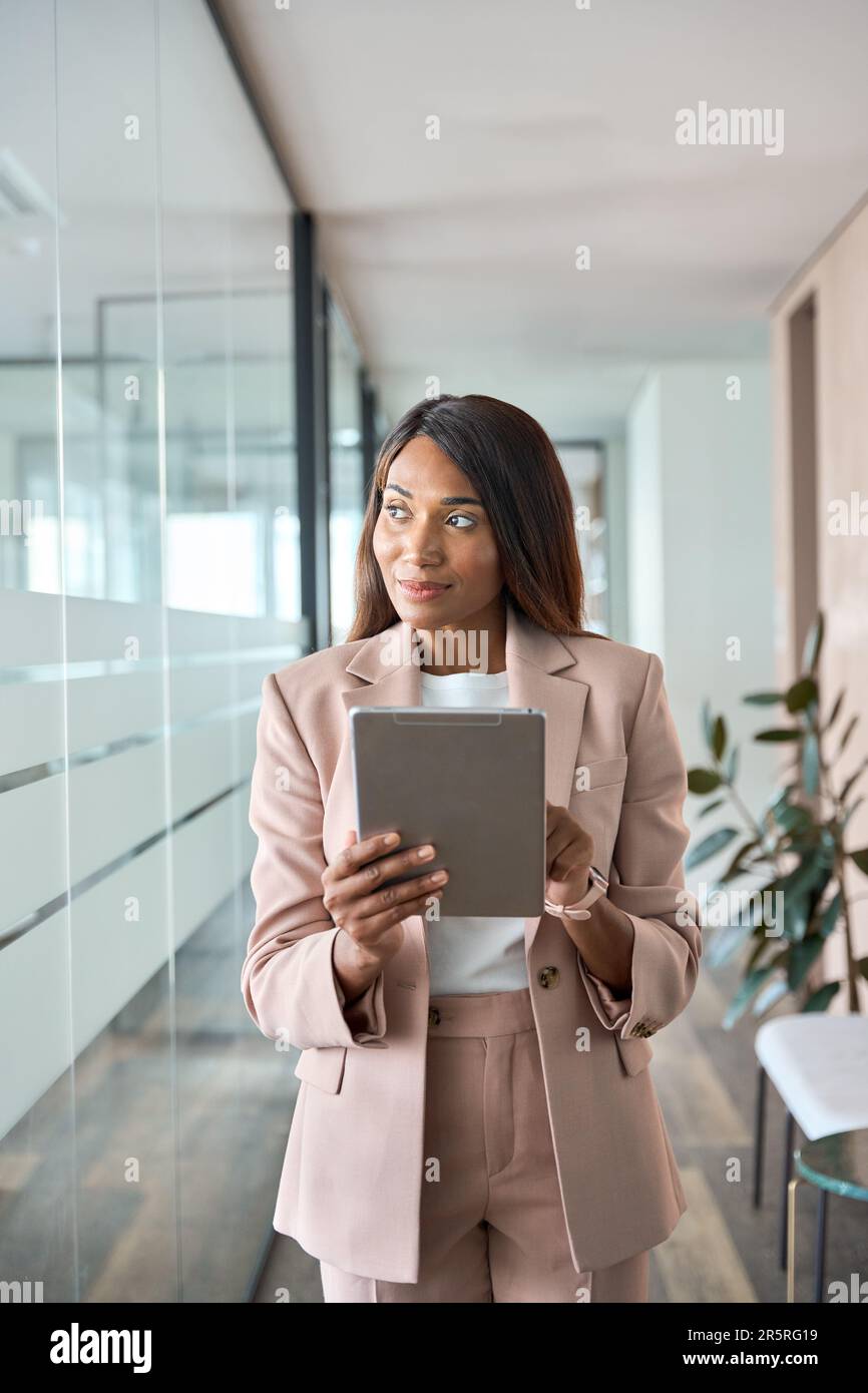 Young African American business woman manager using tablet in office thinking. Stock Photo