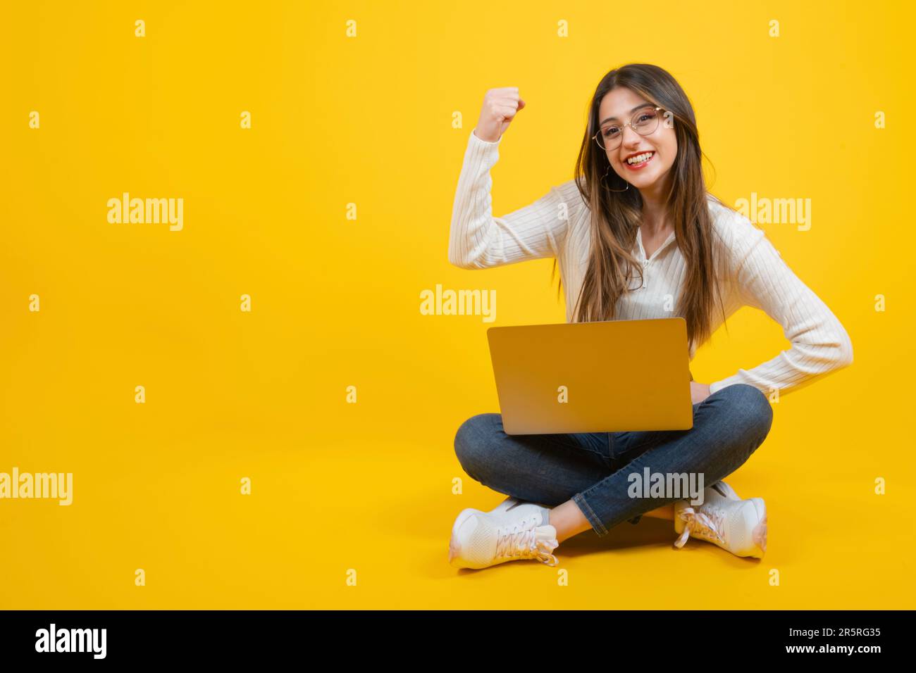 Full body view of strong confident woman. Female boss concept idea. Showing biceps, looking smiling with proud. Feeling success and power. Stock Photo