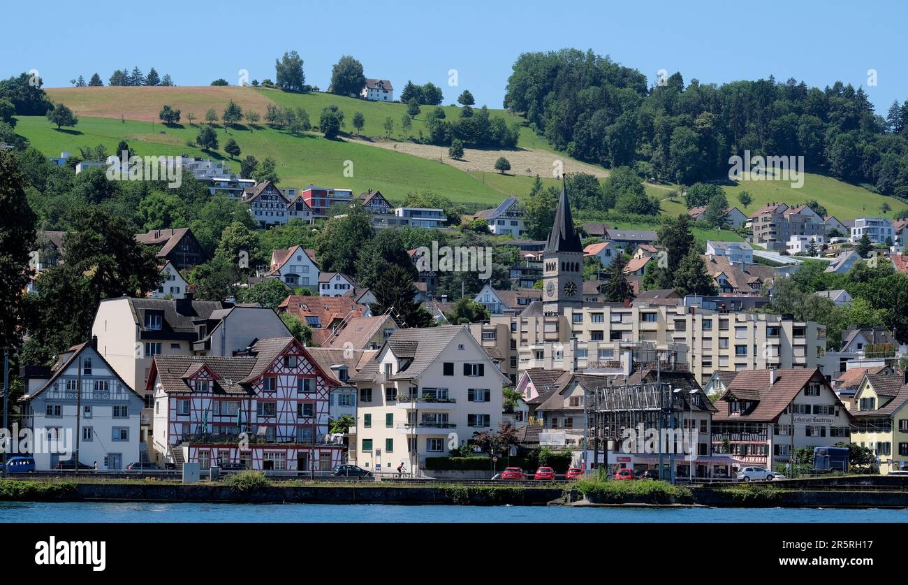 A beautiful shot of historic buildings along the shore near hills in ...