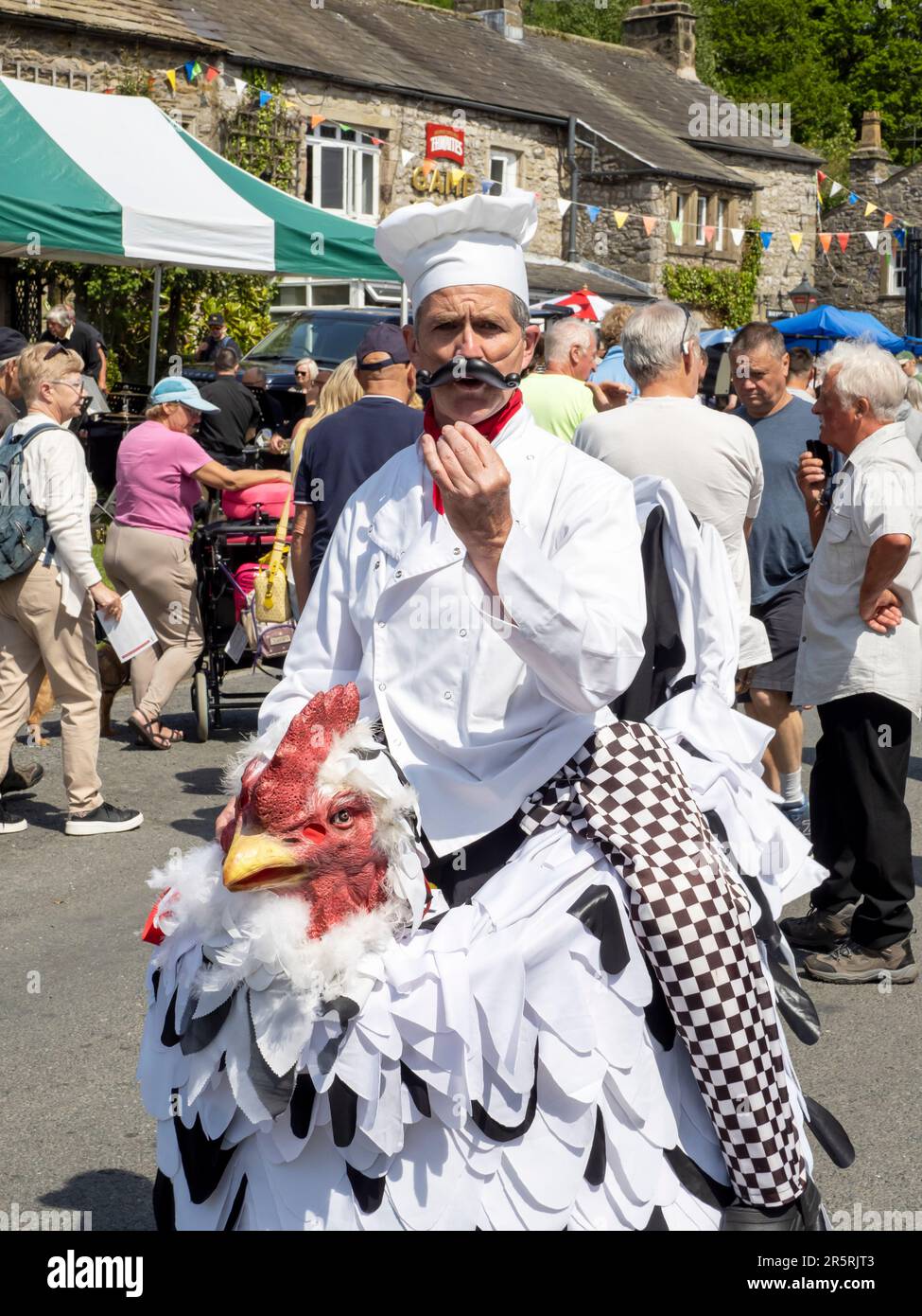 A man dressed up to look like he is riding a chicken at the cuckoo