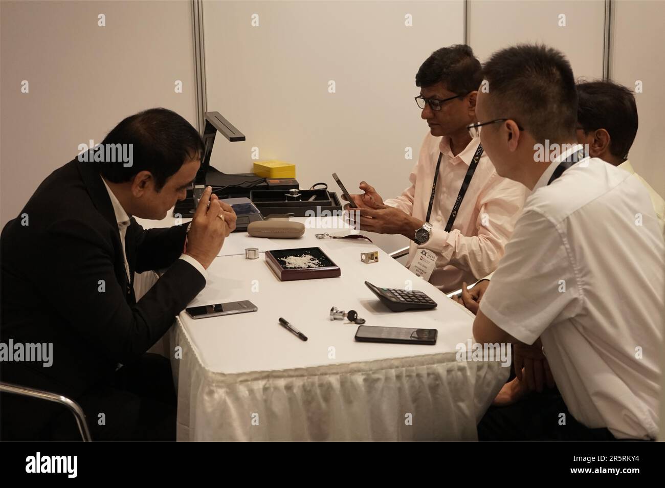 (230605) -- LAS VEGAS, June 5, 2023 (Xinhua) -- A man inspects a lab-grown diamond at the exhibition area of a Chinese lab-grown diamond company during an ongoing North America's leading jewelry show in Las Vegas, the United States, June 2, 2023. TO GO WITH 'Roundup: Chinese lab-grown diamond companies eye opportunities at Las Vegas jewelry exhibition' (Photo by Zeng Hui/Xinhua) Stock Photo