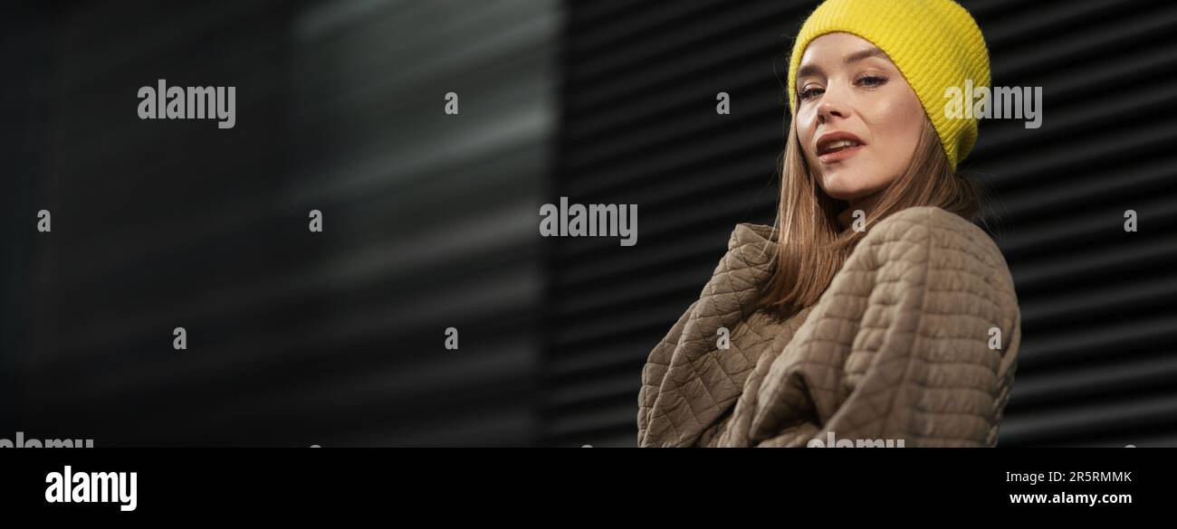 Portrait of young fashionable woman in a city. Stock Photo