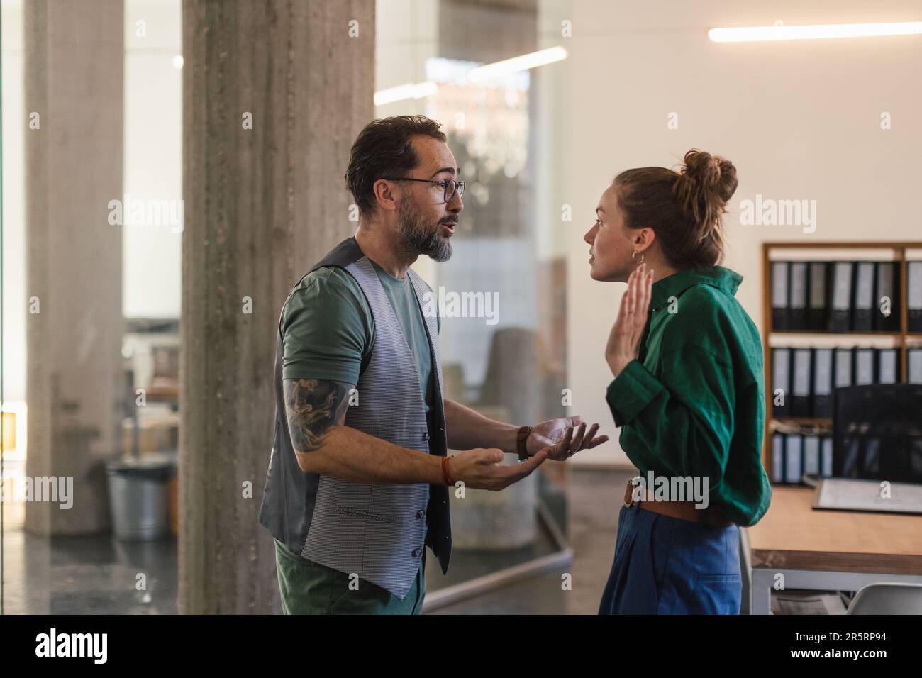 Colleagues arguing in office, problems at work. Stock Photo