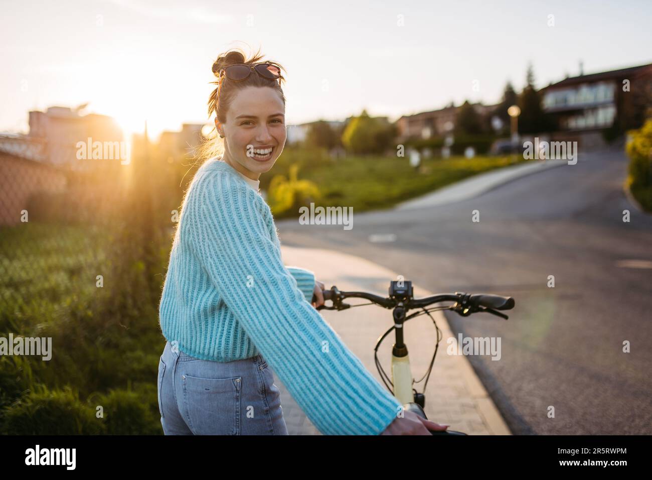 Young woman on electro bicycle, concept of commuting and ecologic traveling. Stock Photo