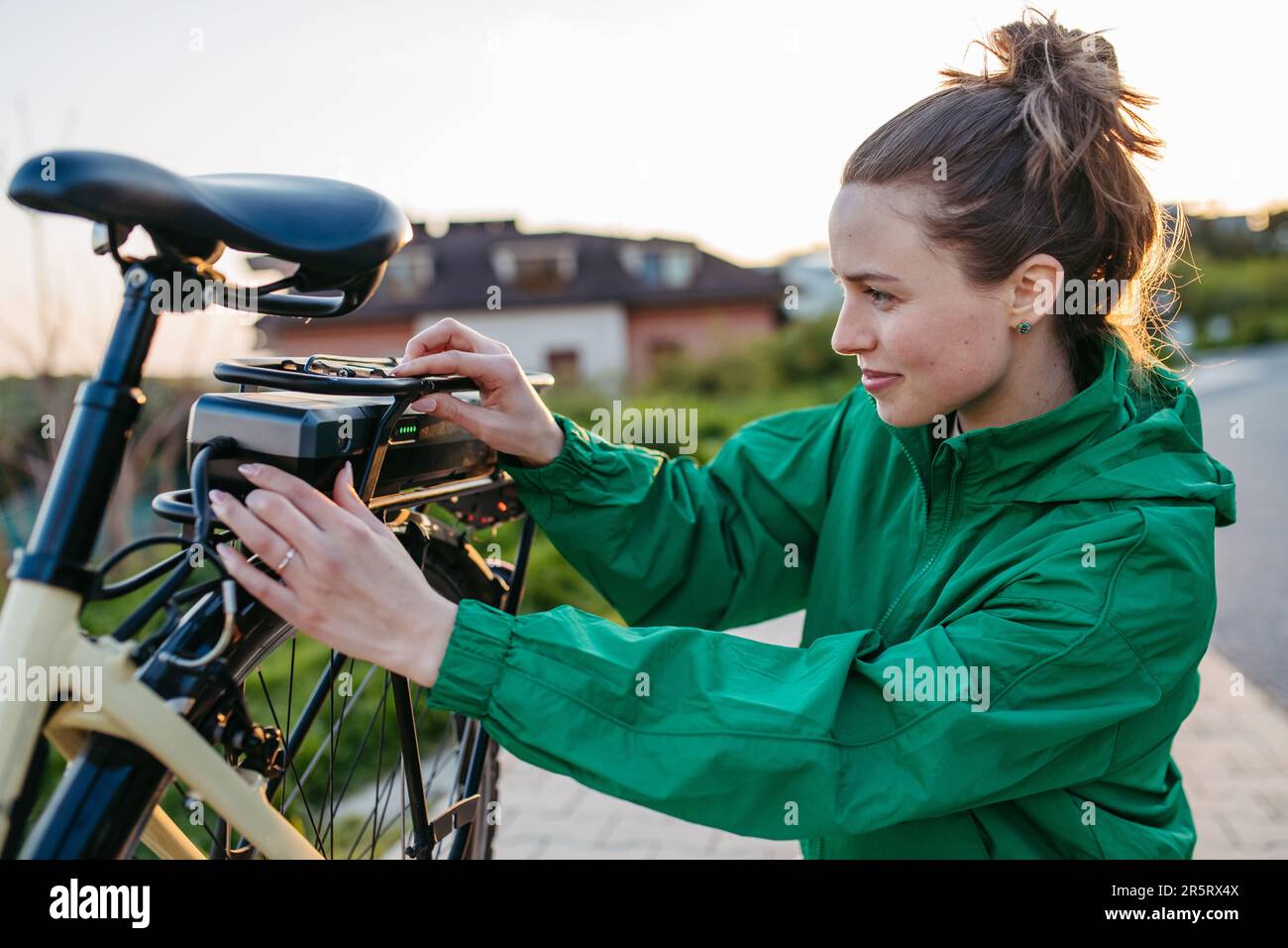 Young woman with electro bicycle, concept of commuting and ecologic traveling. Stock Photo