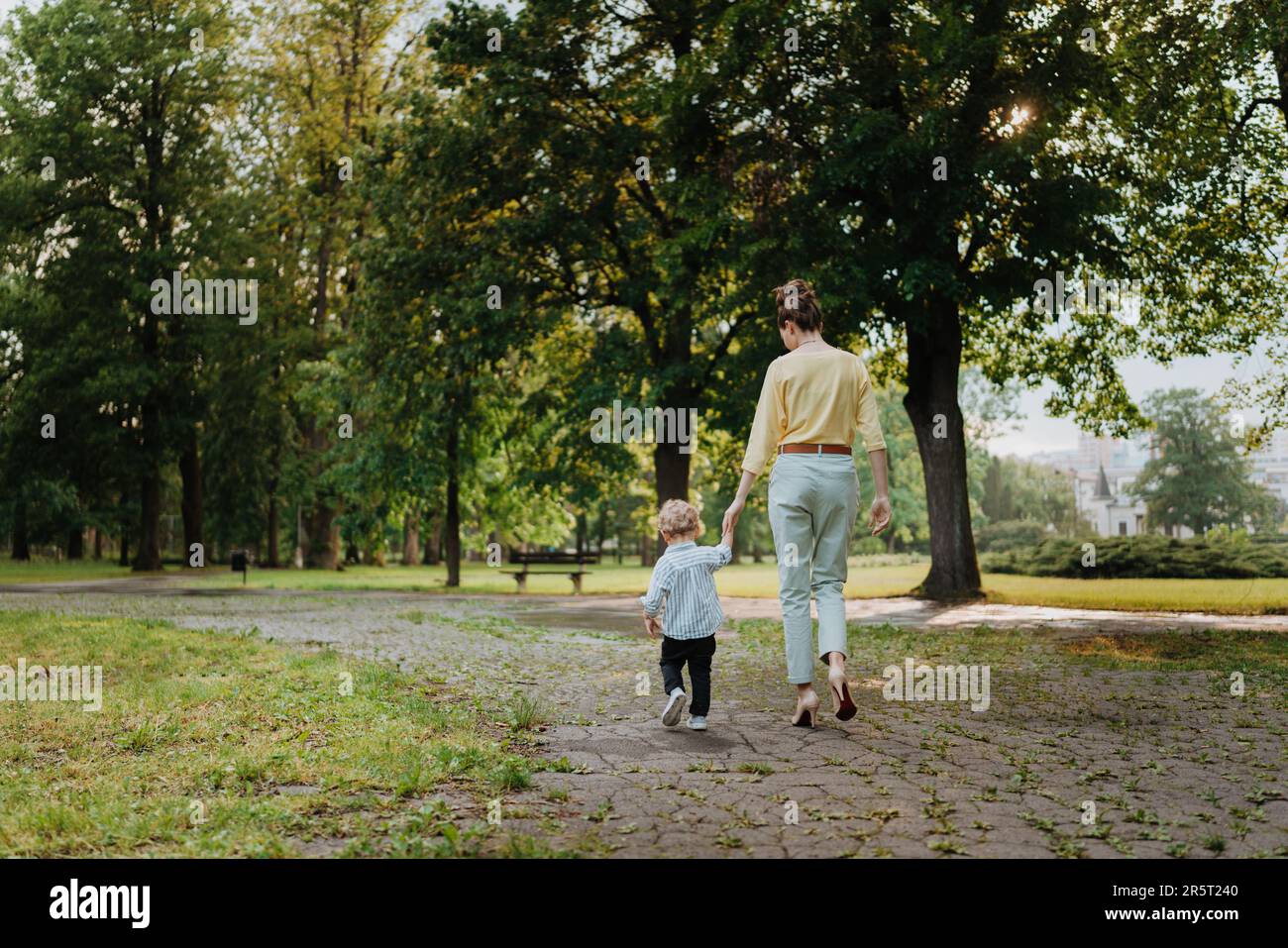 Young mother with little son on together walk after walk. Stock Photo