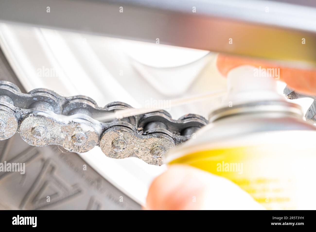 Motorcycle drive chain close up, and grease spray lubricant Stock Photo