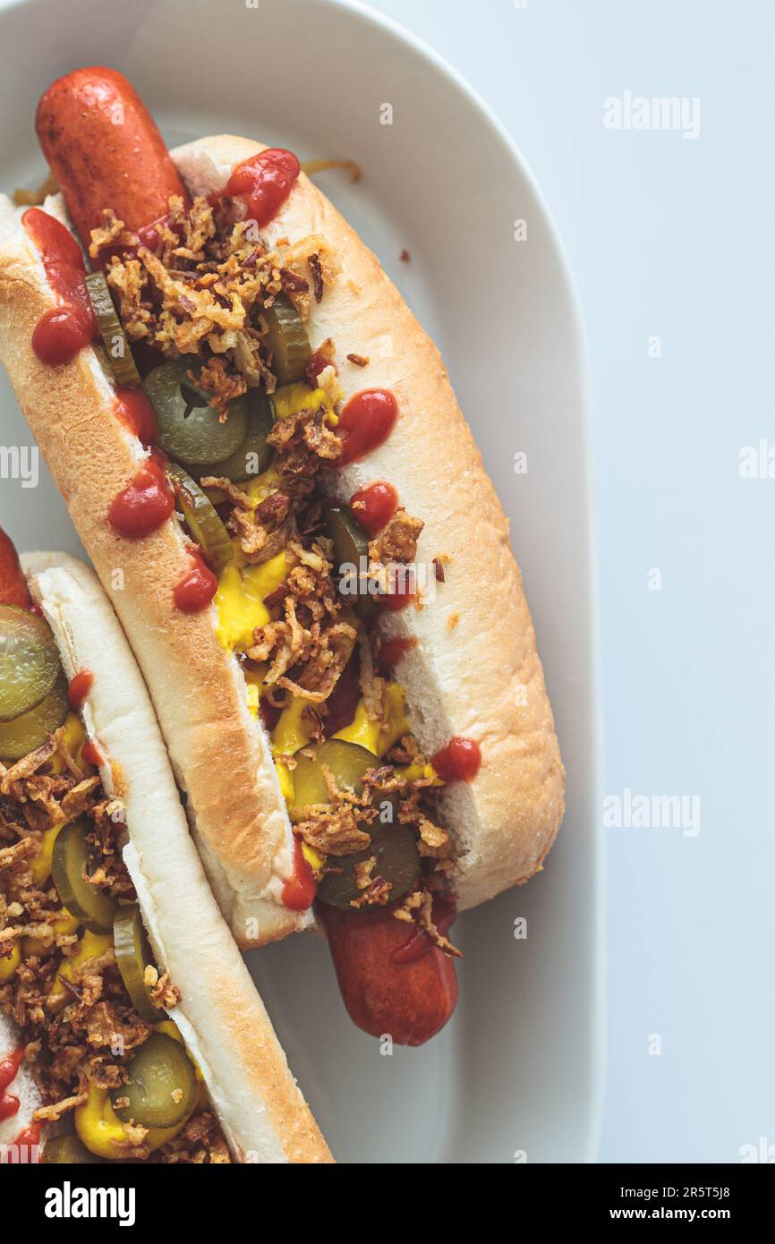 Classic hot dog with mustard, ketchup, pickles and fried onions, top