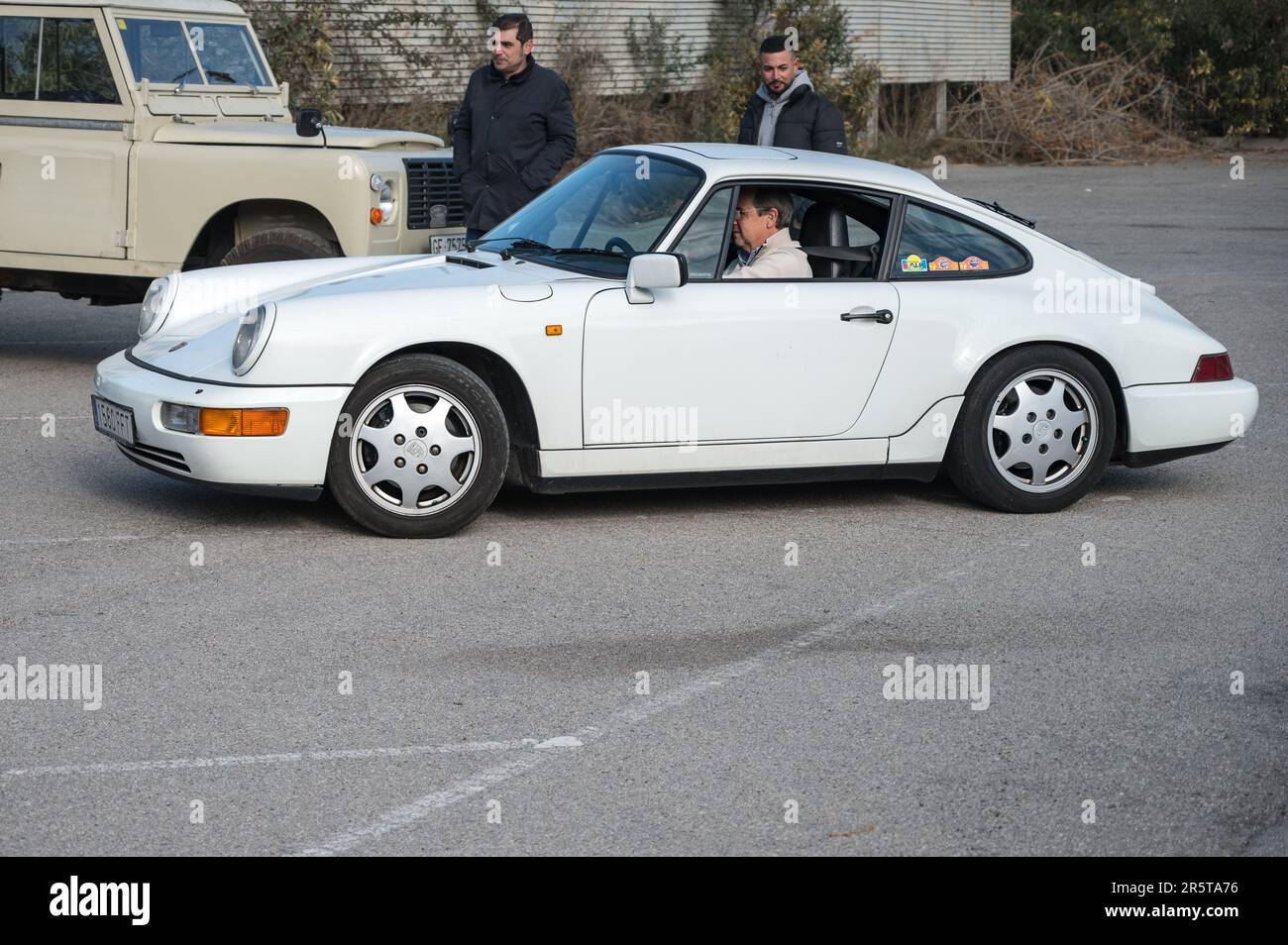 Side view of a classic white colored Porsche 911 964 on the street Stock Photo