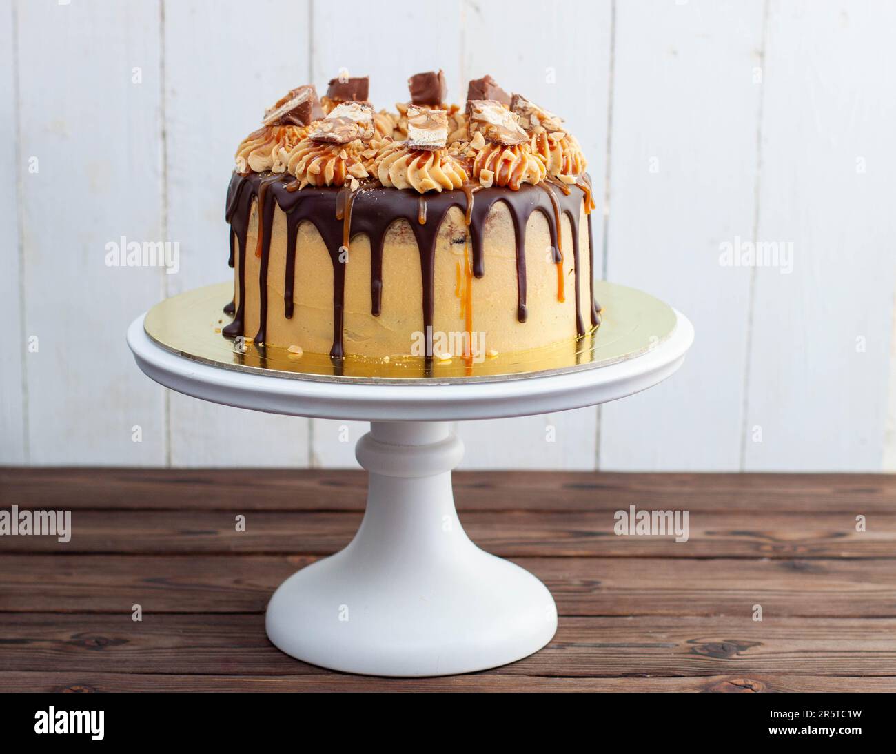 Gorgeous snickers cake with peanut butter cream, melted chocolate ...