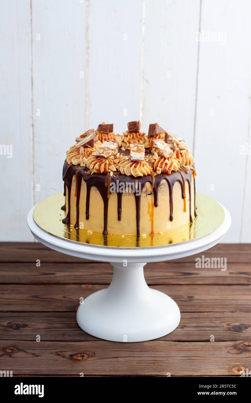 Gorgeous snickers cake with peanut butter cream, melted chocolate ...