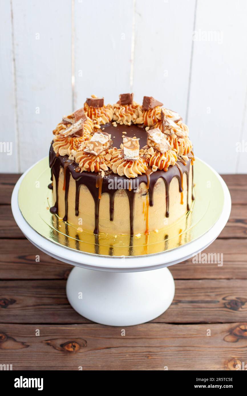 Gorgeous snickers cake with peanut butter cream, melted chocolate ...
