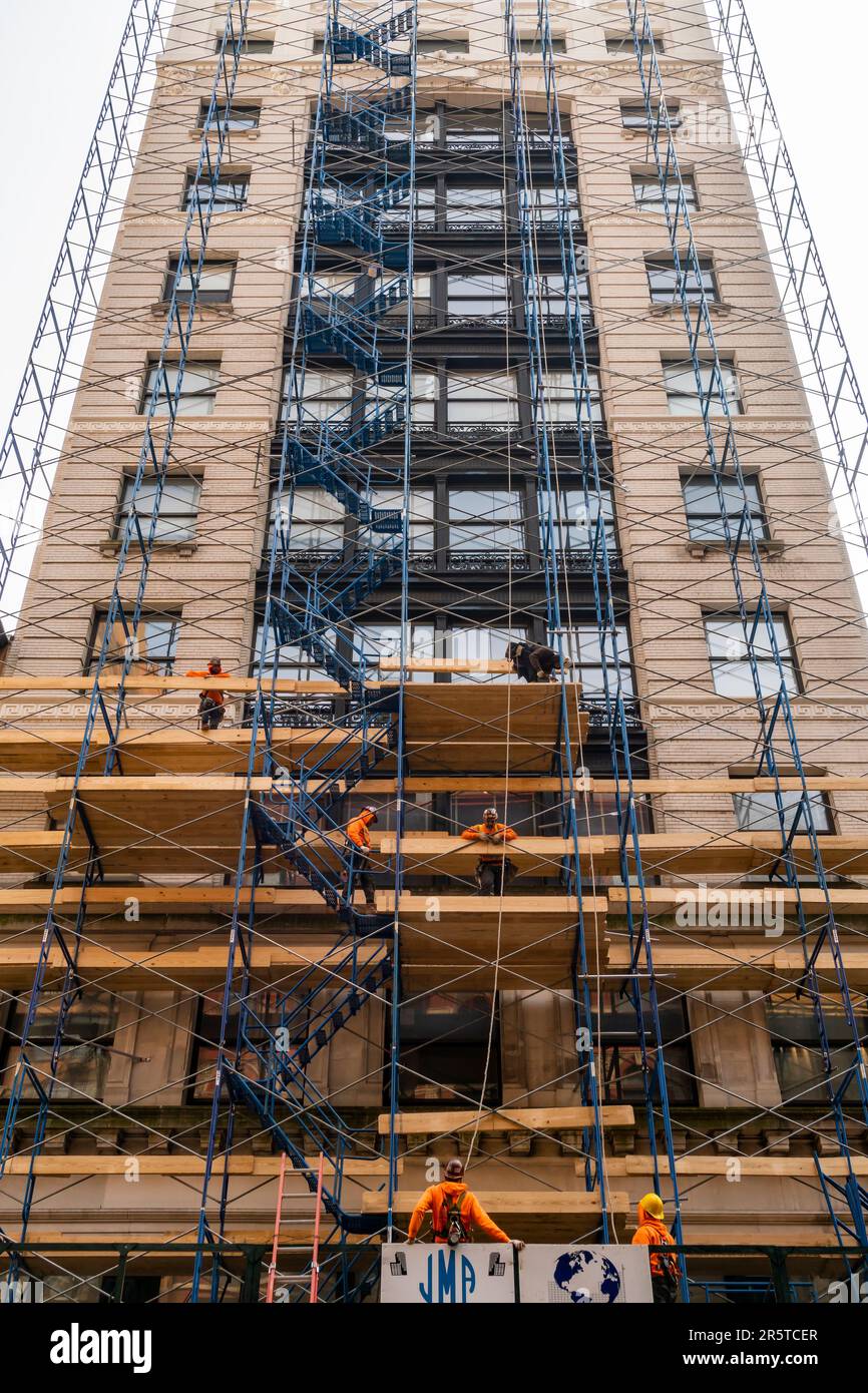 Workers construct scaffolding in the Chelsea neighborhood in New York