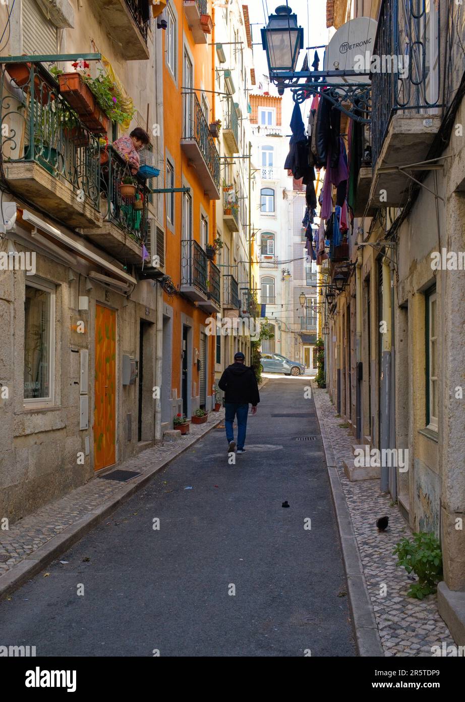 Narrow street with hanging washing in Lisbon Stock Photo