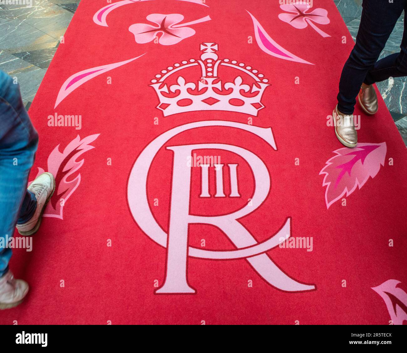 London, UK - April 30th 2023: The cypher of King Charles III, on a red carpet in Burlington Arcade in London, UK. The logo is on display to commemorat Stock Photo