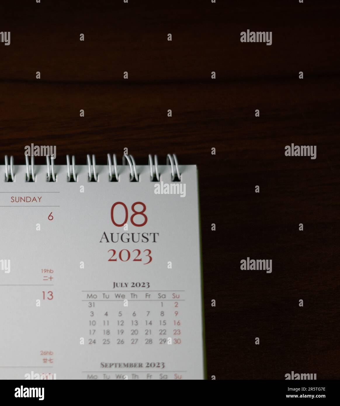 A modern office desk with a desk calendar featuring important dates and events Stock Photo
