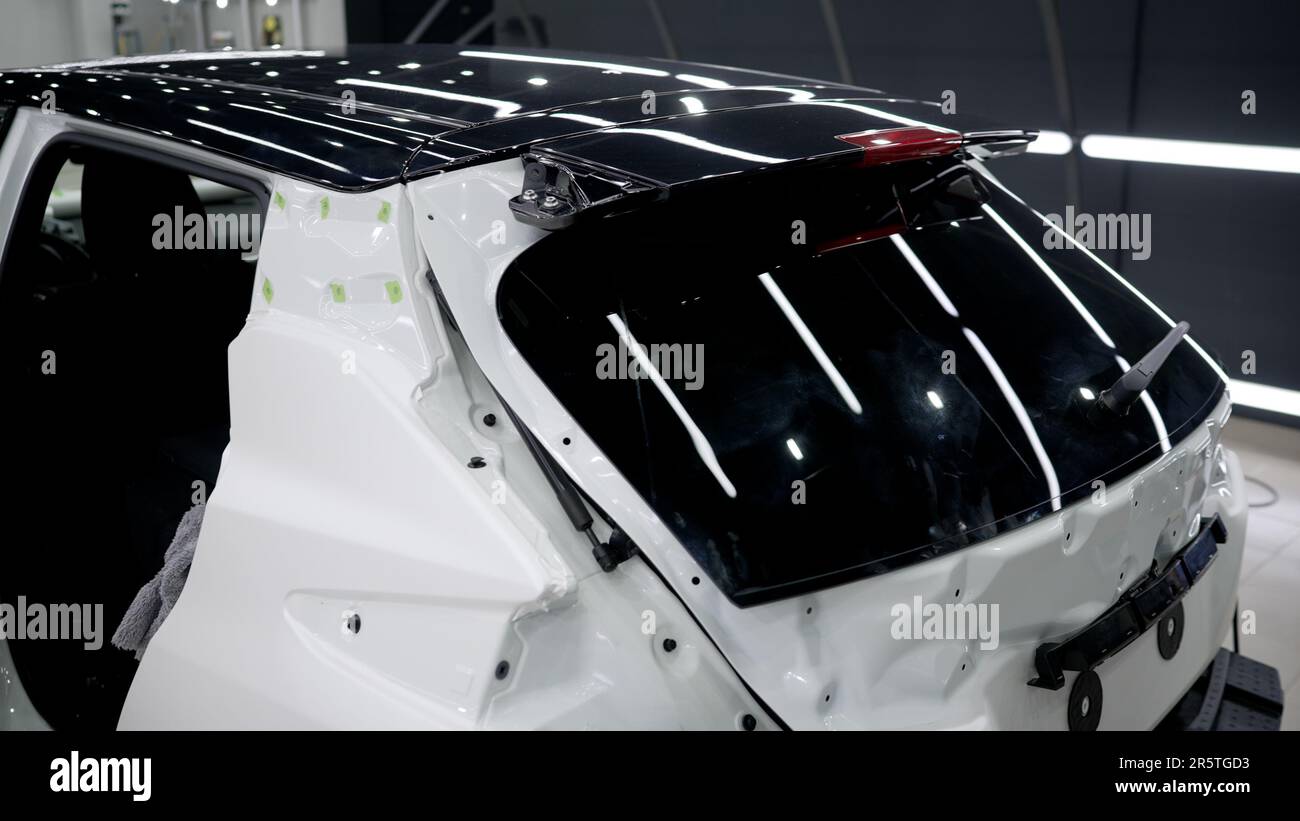 Installing a protective film on the car paintwork. Professional ...