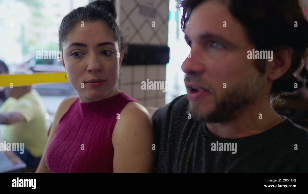Woman reacting with skepticism to what male partner is saying sitting ...