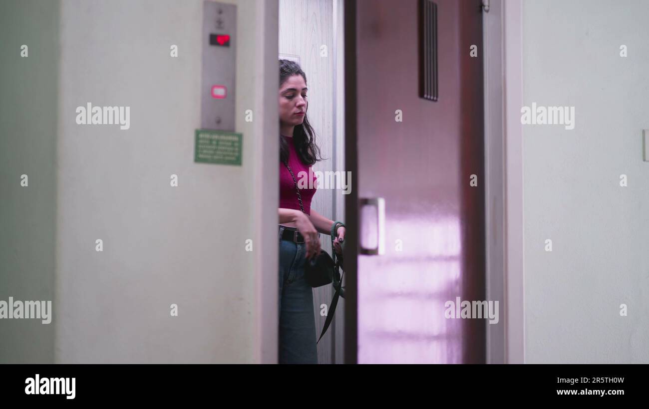 Woman opening elevator door going for a walk with her Dog on a leash