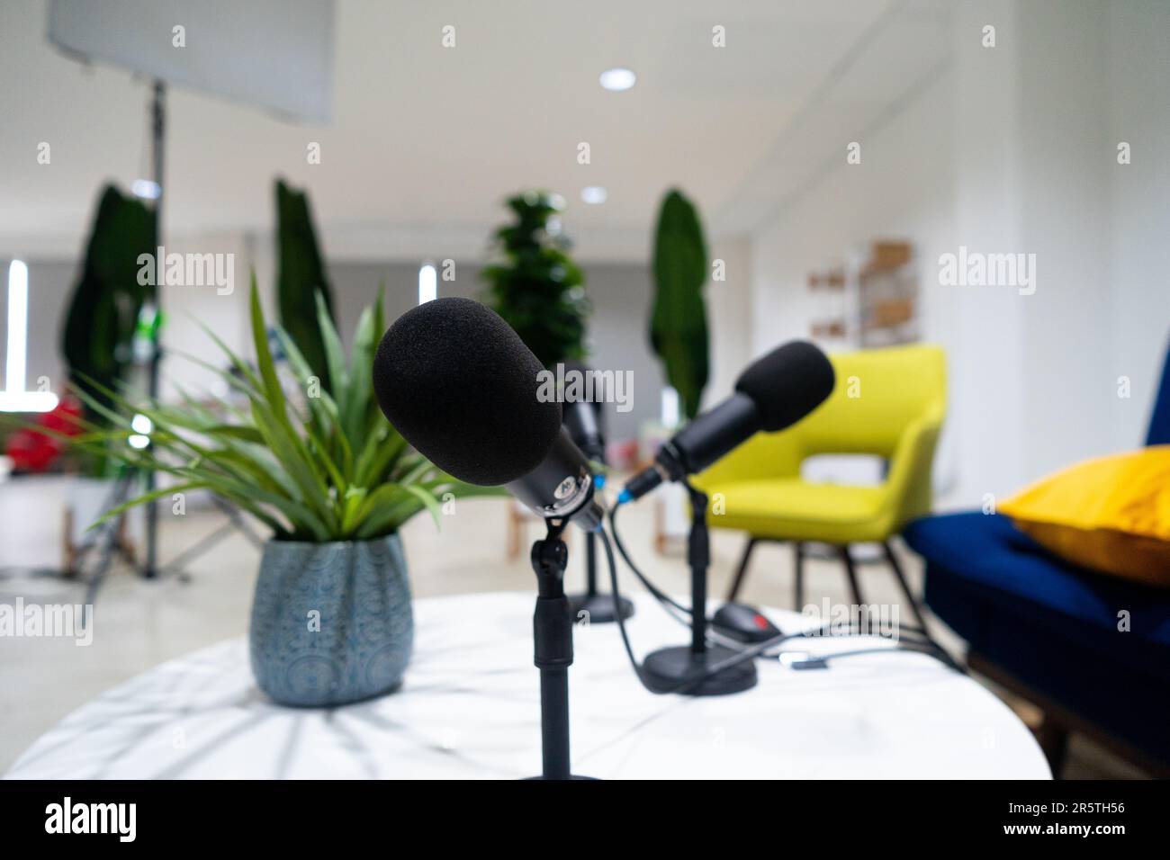 The podcast audio microphone is black. Microphone on the table. Stock Photo