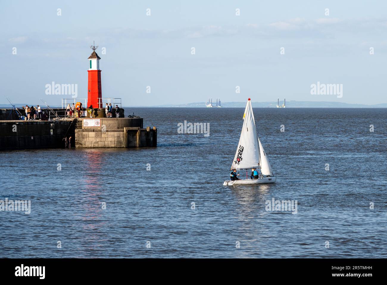 People enjoy sailing, fishing and swimming on a sunny day in Watchet Harbour, West Somerset. Stock Photo