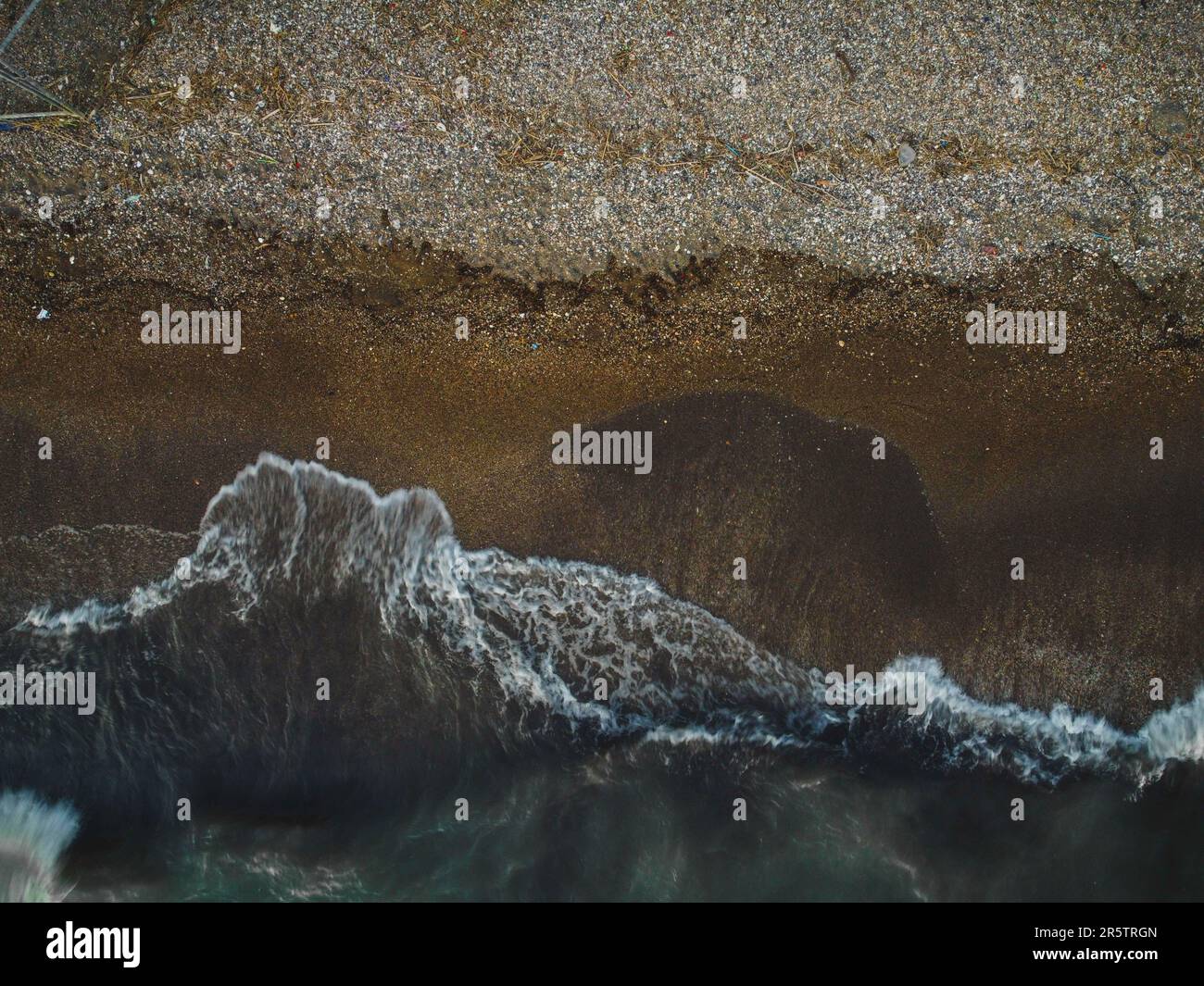 An aerial view of soft ocean waves with foam on a beach Stock Photo - Alamy