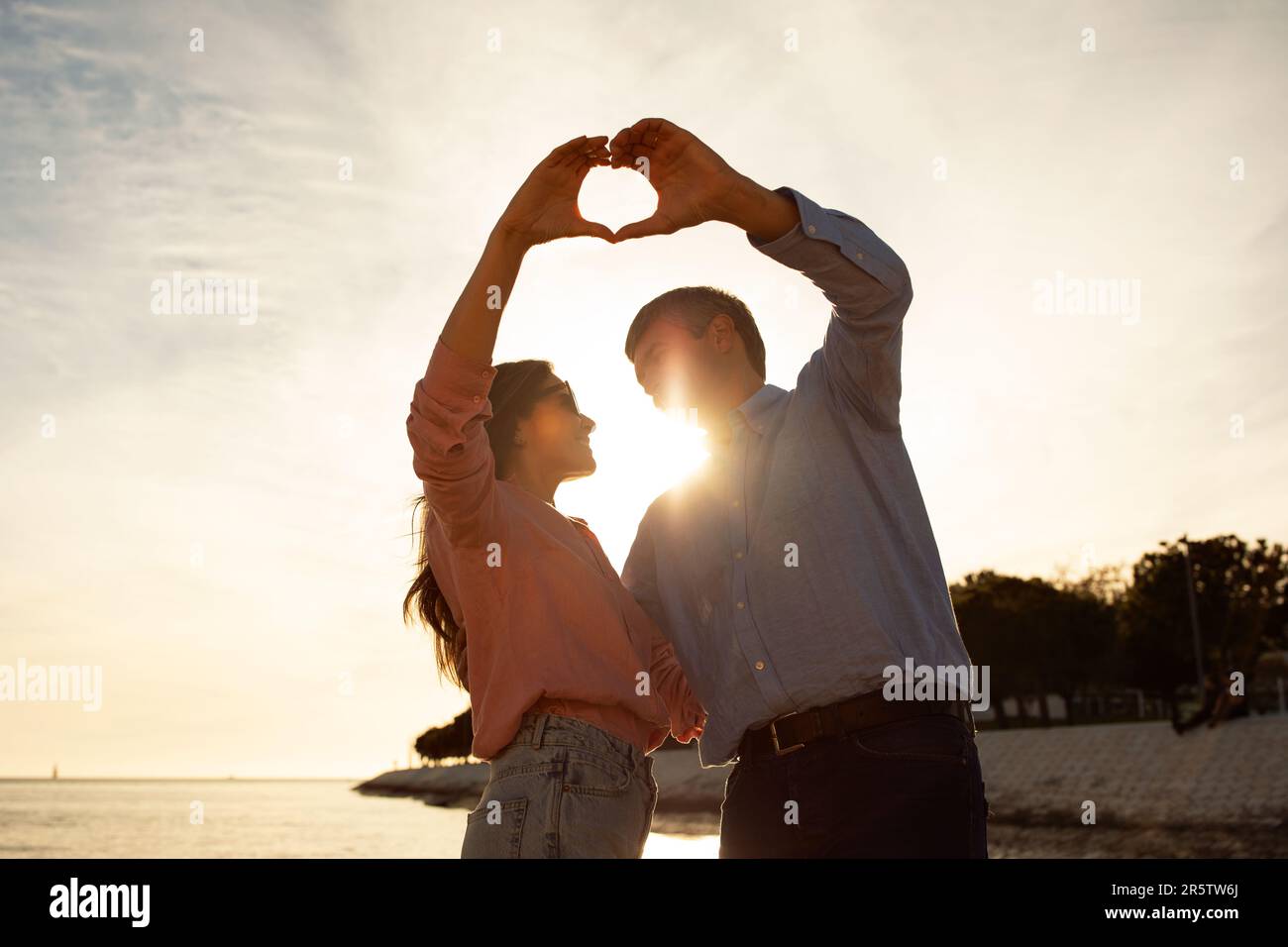 Love Story. Romantic Mature Couple Making Heart Shape With Hands On ...